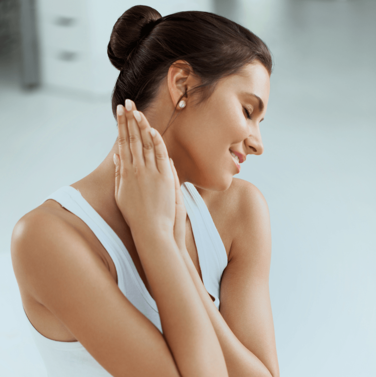Woman touching her neck with a blurred background